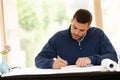 Man, house and architect with plan for design in office, documents and drawing on blueprint. Male person, drafting and Royalty Free Stock Photo