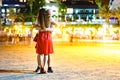 A man is hugging a girl in the street in the evening city. Soft focus, long exposure