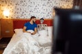 Man and human skeleton watching TV in the bed Royalty Free Stock Photo