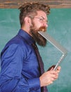 Man hungry for knowledge. He needs new information. Thirst of knowledge. Teacher bearded man bites modern laptop Royalty Free Stock Photo