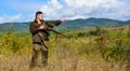 Man hunter aiming rifle nature background. Experience and practice lends success hunting. Guy hunting nature environment Royalty Free Stock Photo