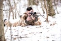 Man hunter shooting with a sniper rifle, aiming and firing bullets