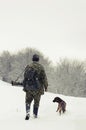 Man hunting with a dog in the forest in winter Royalty Free Stock Photo