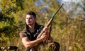 Man hunting wait for animal. Hunter with rifle ready to hunting nature background. Hunting strategy or method for