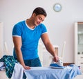 Man husband ironing at home helping his wife Royalty Free Stock Photo