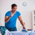 Man husband ironing at home helping his wife Royalty Free Stock Photo