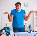 Man husband ironing at home helping his wife Royalty Free Stock Photo