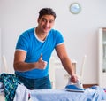 Man husband ironing at home helping his wife Royalty Free Stock Photo