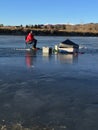 Man ice fishing on blue ice under blue sky 2. Royalty Free Stock Photo