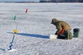 Man ice fishing on a frozen lake