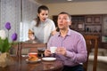 Man ignoring disgruntled wife reprimanding him