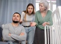 Man ignoring two women arguing at home Royalty Free Stock Photo