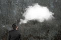 Man imagining white cloud thought bubble above his head