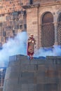 Man In Inca King Costume Standing On Wall With Smoke Peru