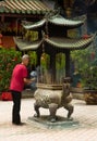 Man with incense in a temple in Singapore