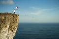 Man with indonesian flag of indonesia on top of the mountain