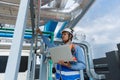 Man Industrial engineer with walkie talkie pointing work at rooftop construction. Male technician working checking HVAC system Royalty Free Stock Photo