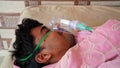 Man infected with Covid 19 disease. Patient inhaling oxygen wearing mask with liquid Oxygen flow