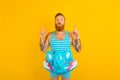man with inflatable donut with elephant is ready to swim Royalty Free Stock Photo
