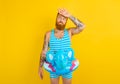 man with inflatable donut with elephant is ready to swim Royalty Free Stock Photo