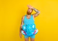 man with inflatable donut with elephant is ready to swim Royalty Free Stock Photo