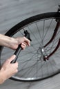 Man inflates a wheel on a bicycle close-up. bicycle repair Royalty Free Stock Photo