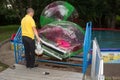 Man inflates zorb with little girl