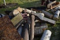 Man injured with ax while working with wood for heating. blood and severed fingers in a pile of cut logs and planks. old blunt ax