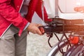 Man inserting battery in backseat of electric bicycle Royalty Free Stock Photo