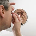 Man inserting a contact lens