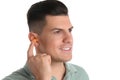 Man inserting foam ear plug on white background Royalty Free Stock Photo