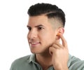 Man inserting foam ear plug on white background Royalty Free Stock Photo