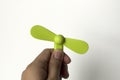 A man is inserting a green mini fan to a power bank