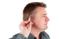 Man inserting a hearing aid into ear Royalty Free Stock Photo