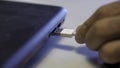 Man inserting usb cable into laptop. Media Royalty Free Stock Photo