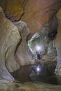 Man inside cave with headlight Royalty Free Stock Photo