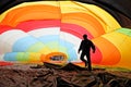 Man inside a colorful hot air balloon inflating Royalty Free Stock Photo