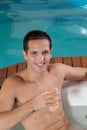 Man inside a jacuzzi drinking juice Royalty Free Stock Photo