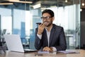 A man inside the office writes down the main message using an application on the phone, a smiling businessman works with Royalty Free Stock Photo