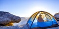 Man inside a tent in Yosemite with Half Dome view