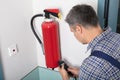 Man Inspecting Fire Extinguish Royalty Free Stock Photo