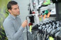 Man inspecting golf clubs Royalty Free Stock Photo