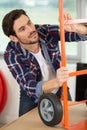 man inspecting new orange trolley Royalty Free Stock Photo