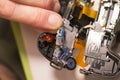 Man inspects disassembled photocamera. Royalty Free Stock Photo