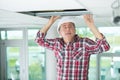 Man install suspended ceiling in house Royalty Free Stock Photo