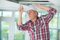 Man install suspended ceiling in house Royalty Free Stock Photo