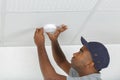 Man during installation smoke detector