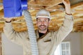 man during installation ventilation pipes