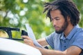 man installing car roof cargo container before vacation road trip Royalty Free Stock Photo