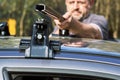 Man installing a car roof rack outdoors Royalty Free Stock Photo